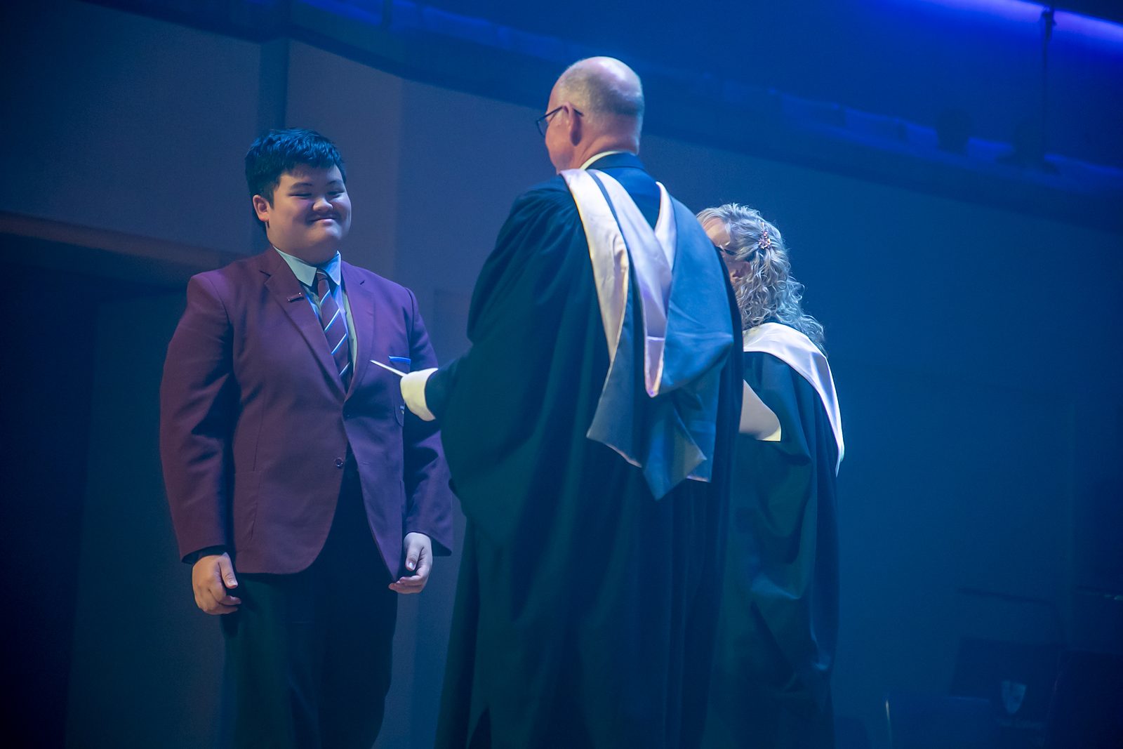 John Song being presented on stage at John Paul College Speech Night