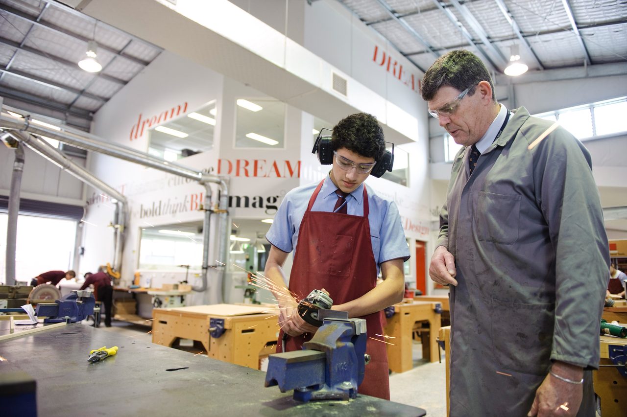 A student working with a teacher in the Applied Design workshop