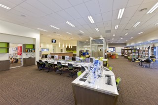 Students working in a bright, modern John Paul College learning centre