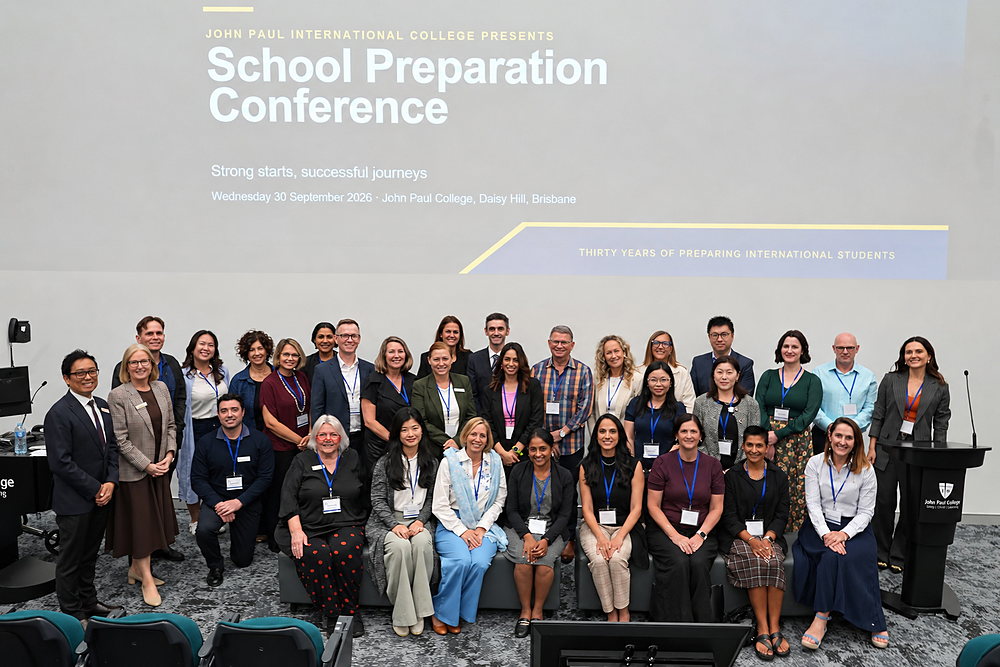Delegates and presenters gather for a group photo in the lecture theatre at the School Preparation Conference 2026, John Paul College, Brisbane