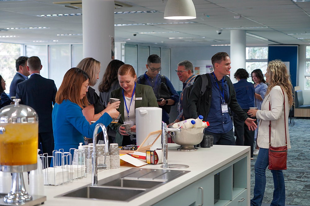 Delegates talk over refreshments during a break at the School Preparation Conference