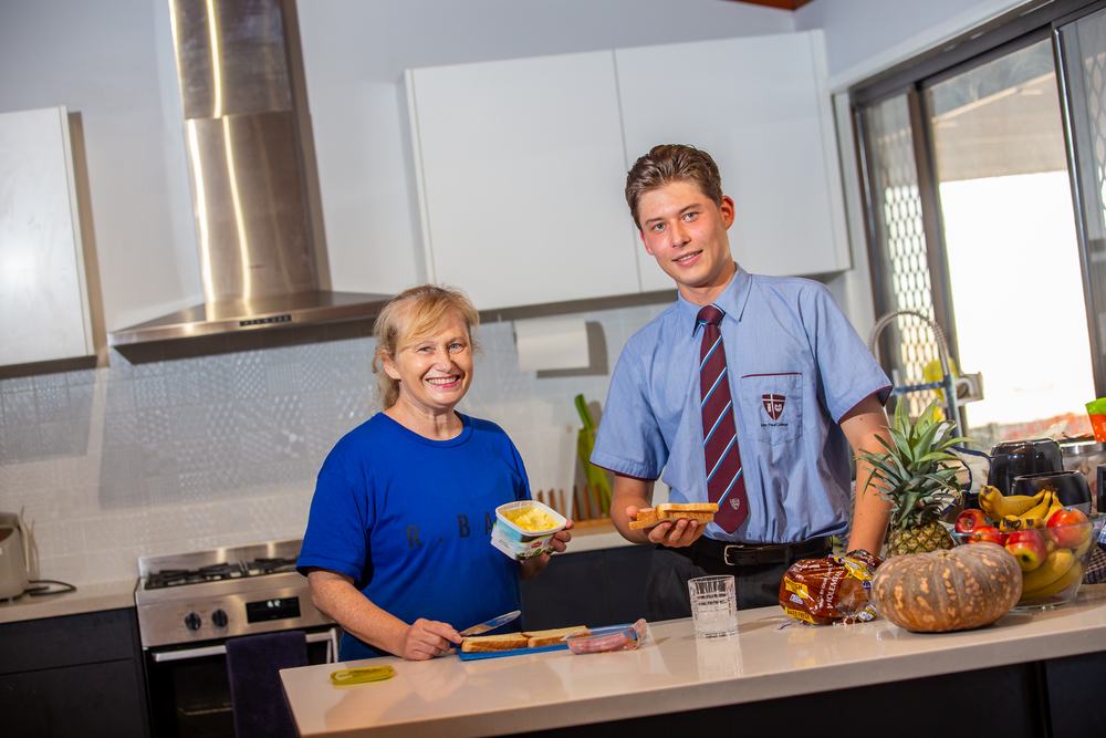 An international student cooking at home with their Australian host family on the weekend