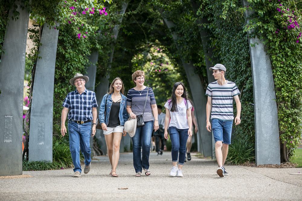 Homestay students and family walking through the JPC campus