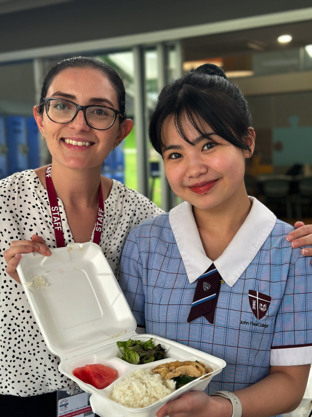 A John Paul College staff member and an international student with an Extended Day Program evening meal