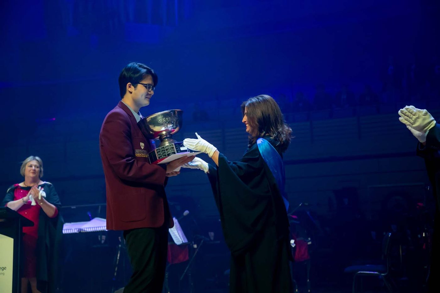 Nam Nguyen receiving the Dux trophy from a member of College staff