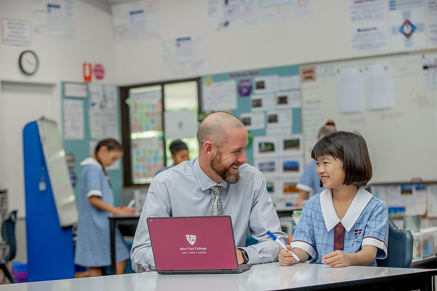 A primary teacher working closely with engaged students
