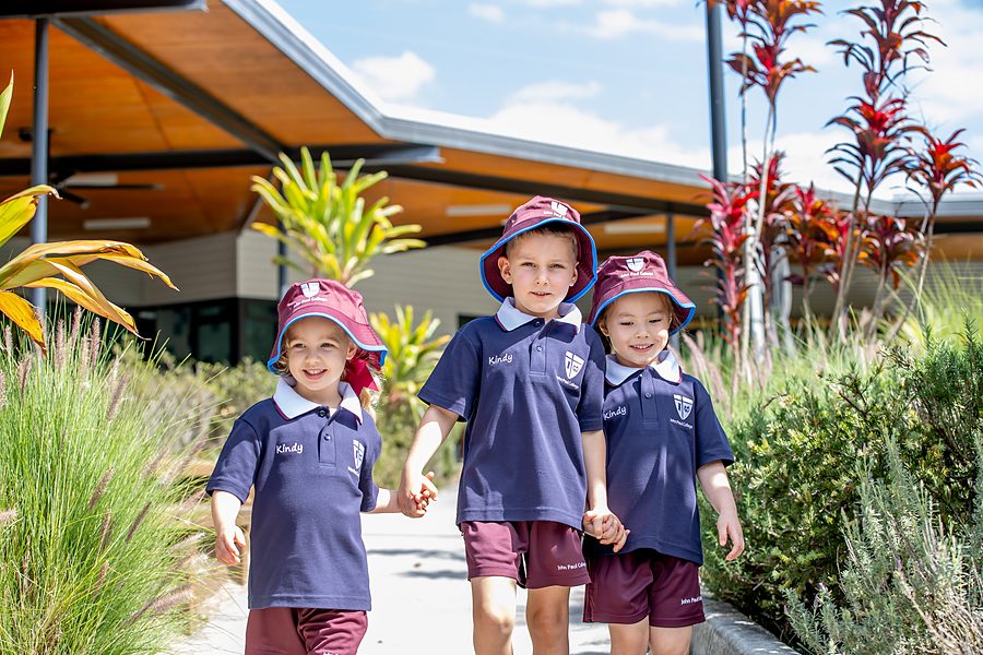 Prep children holding hands and beaming as they walk together