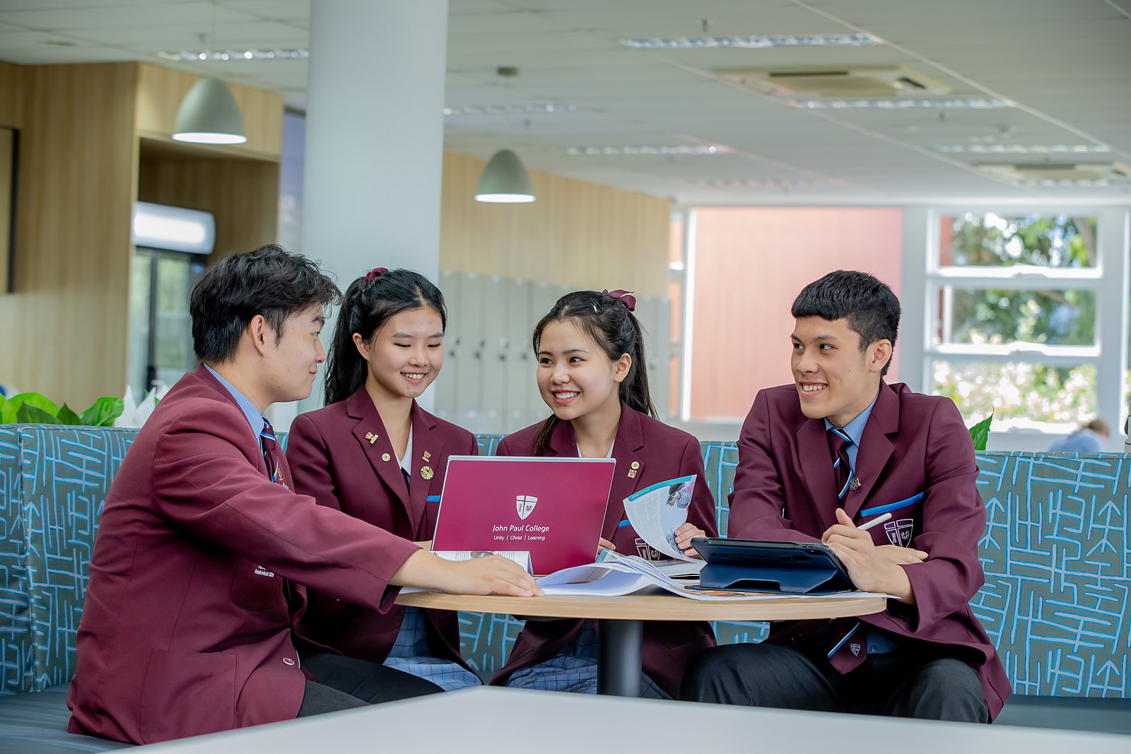 International students studying together in a modern break-out space