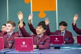 Secondary students engaging with laptops in class