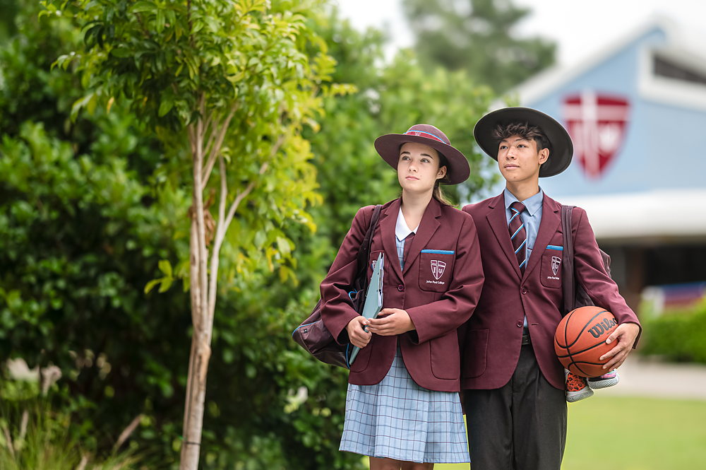 Two John Paul College students walking together on the Daisy Hill campus