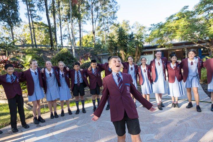 Secondary students celebrating together outdoors