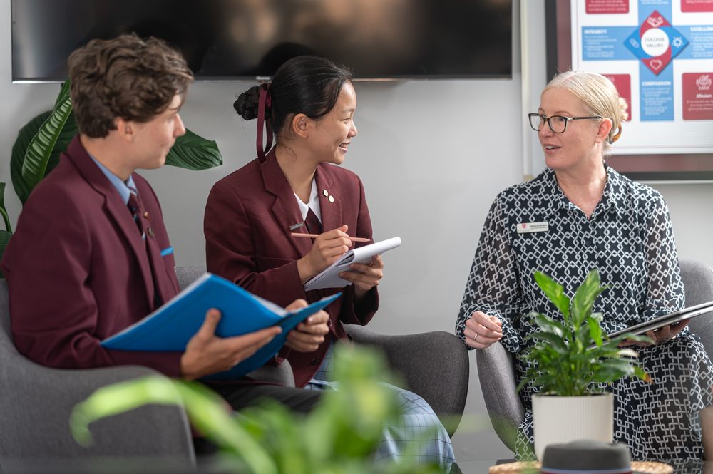 Two John Paul College international students talking with a wellbeing staff member